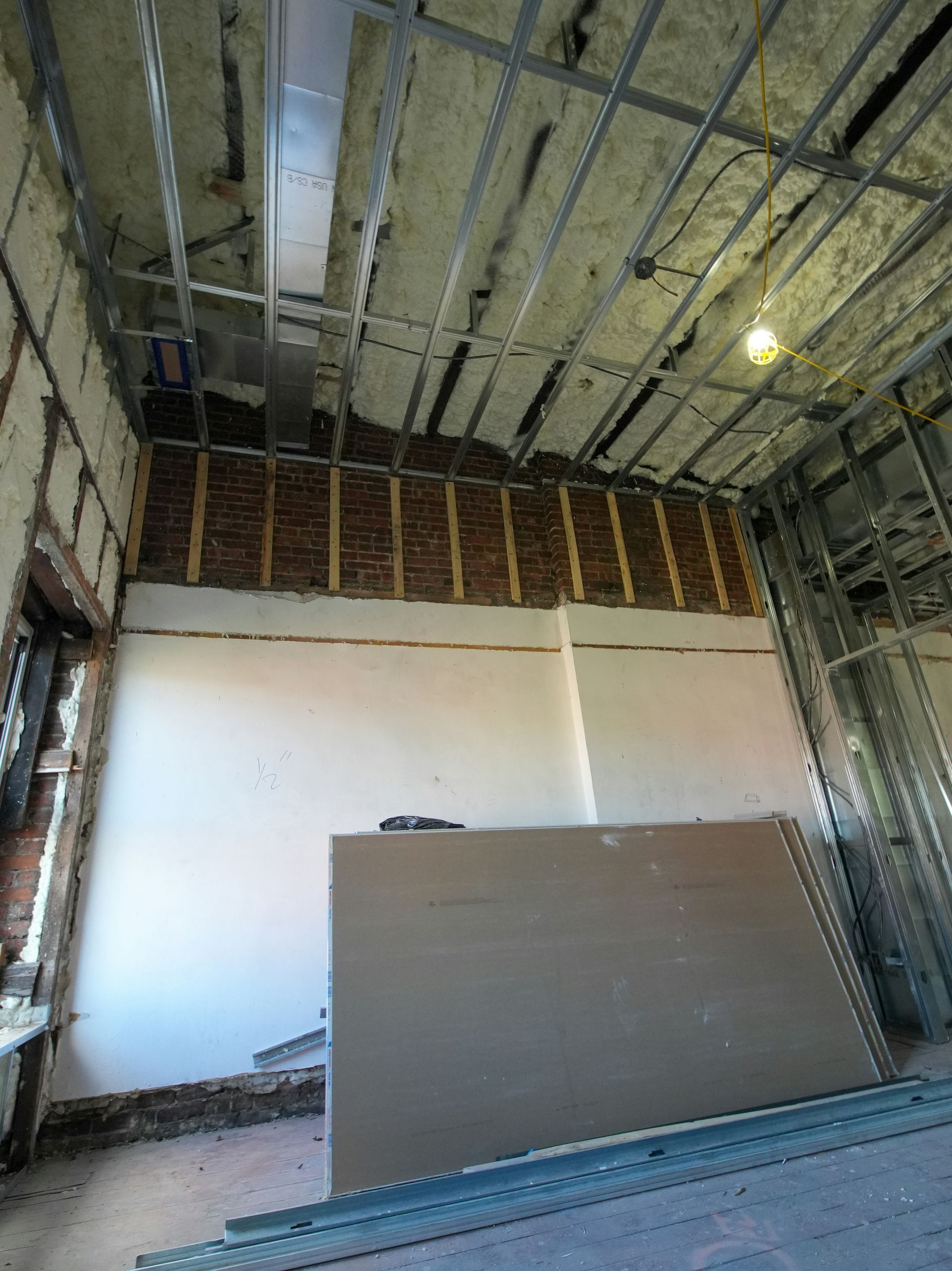 Interior construction with exposed brick and drywall sheets